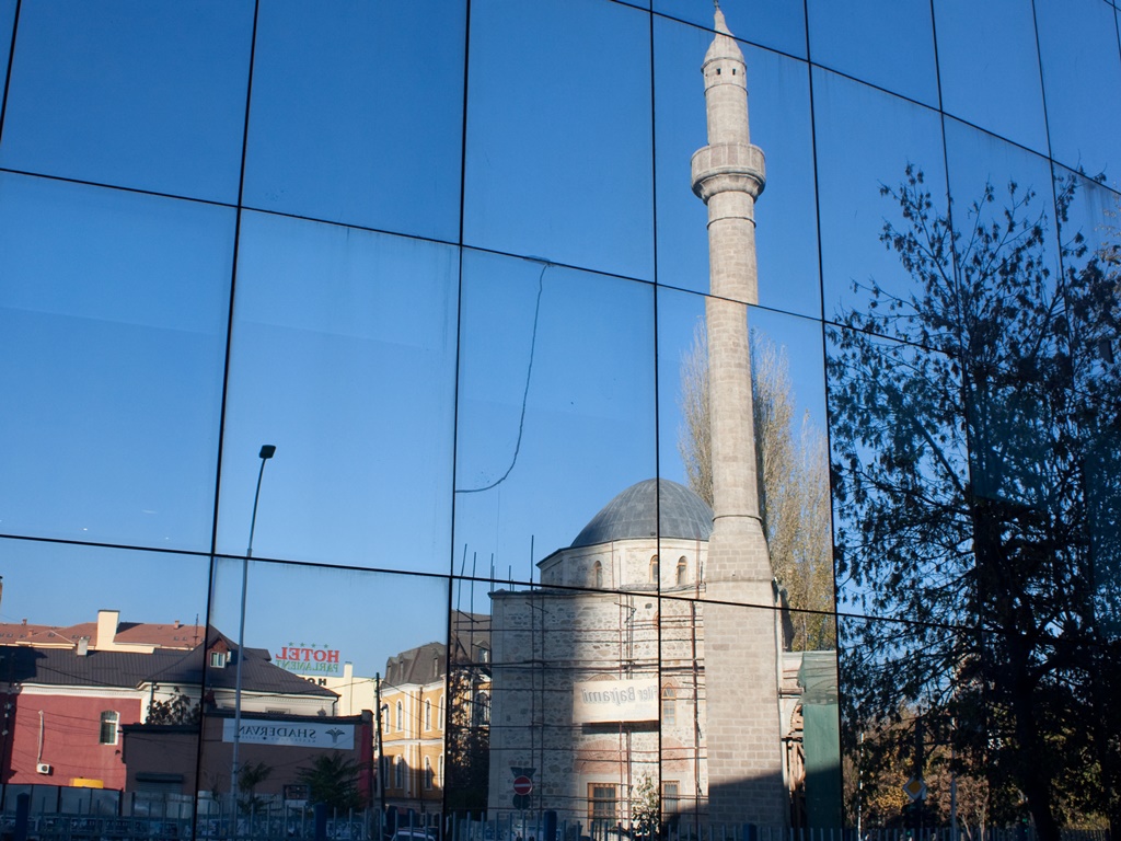 mosque reflects in window